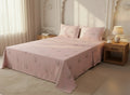AthSVi Alayam blush pink floral print bed sheet set with matching pillowcases on a made bed in a serene bedroom.