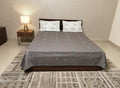 AthSVi Alayam grey cotton bed sheet set with traditional white and charcoal floral motifs and matching pillowcases.