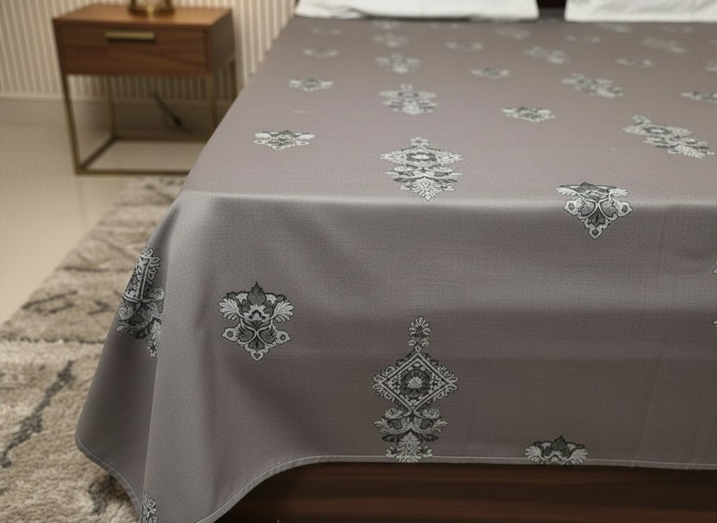 AthSVi Alayam grey cotton bed sheet with intricate white and charcoal floral traditional print on a made bed