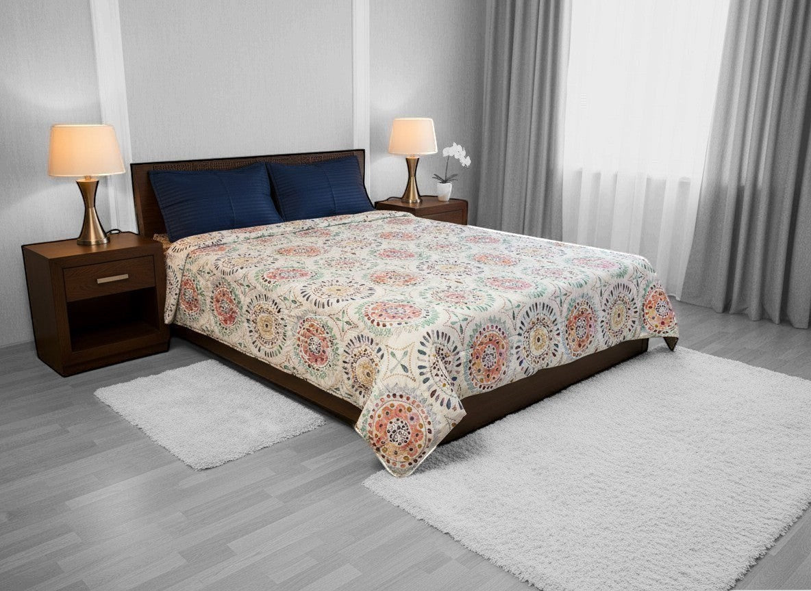 AthSVi Alayam king size cotton comforter with multicolour Jaipuri medallion block print on a white base on a bed