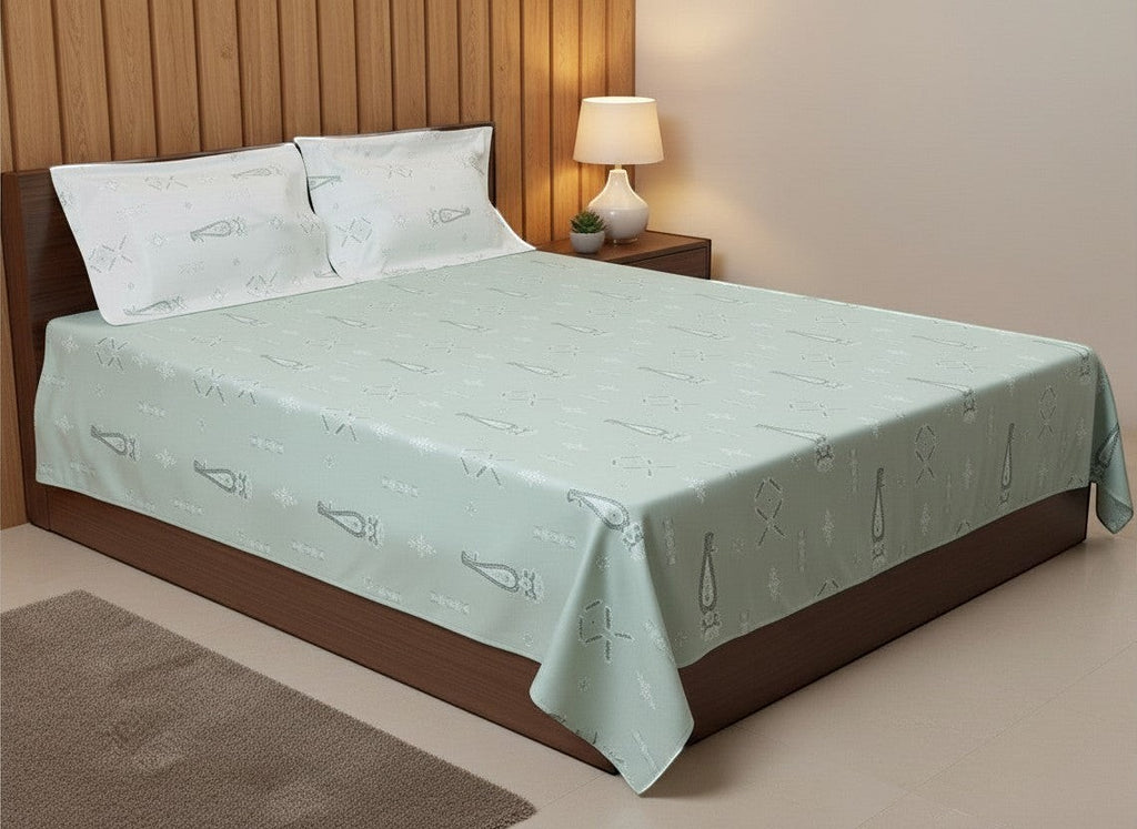 AthSVi Alayam sage green cotton bed sheet set with traditional white motifs and matching pillowcases on a bed.