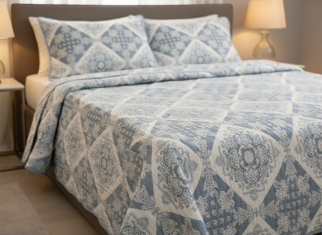AthSVi Alayam steel blue and white diamond patchwork quilted cotton bed cover with matching pillow covers on a bed.