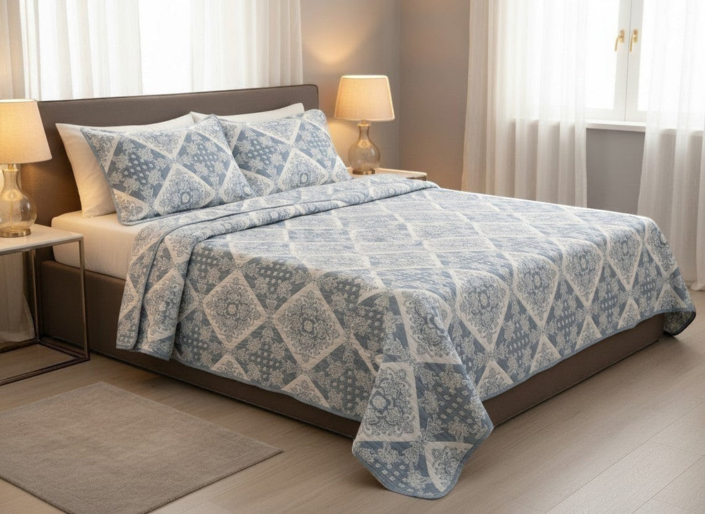 AthSVi Alayam steel blue and white diamond patchwork quilted cotton bed cover with matching pillow covers on a double bed.