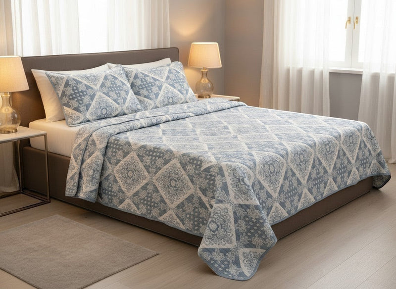 AthSVi Alayam steel blue and white diamond patchwork quilted cotton bed cover with matching pillow covers on a double bed.